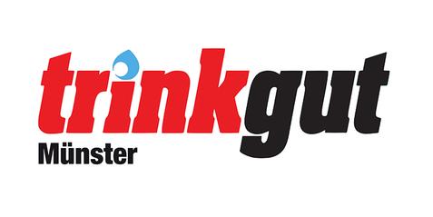 Logo von Trinkgut mit dem Schriftzug &bdquo;trinkgut&ldquo; in rot und schwarz sowie dem Zusatz &bdquo;M&uuml;nster&ldquo; in schwarz.